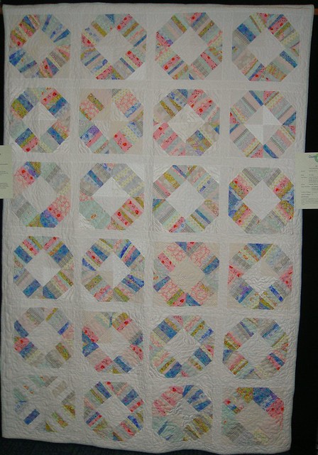Bee Happy Liberated Wedding Ring Quilt hanging in the first Los Angeles 