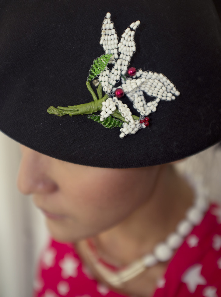 We have fun with our brooches, as you can see. Here, a 1960s white beaded leaf brooch stands out against a black beret. 