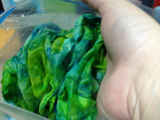 The scarf is in the bag, many shades of blue and green
