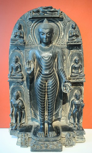 Lord Buddha surrounded by figures depicting aspects of his life story, enlightenment, and his death (parinirvana), mudra of giving, carved black stone, Art Institute of Chicago, Illinois, USA by Wonderlane