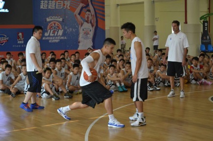 August 19th, 2012 - Jeremy Lin instructsa a basketball camp attendee during the first day of his basketball camp in Dongguan