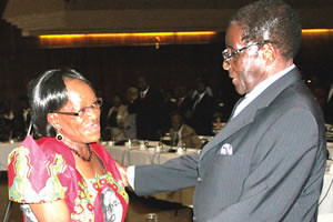 President Mugabe chats with Politburo member Cde Tsitsi Muzenda before the Zanu-PF Central Committee meeting in Harare on March 30, 2012. Mugabe says that elections will be held this year in the Southern African state. by Pan-African News Wire File Photos