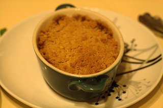 Closeup photo of an individual portion of apple crumble, just after cooking.