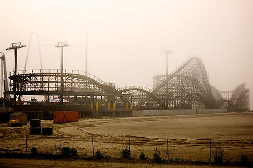 Wooden roller coaster covered in fog.