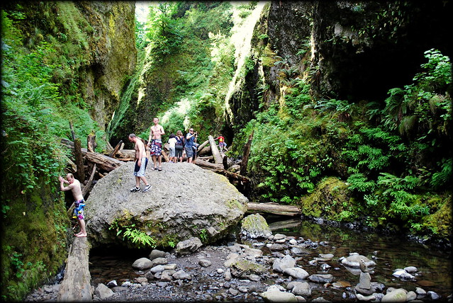 Hikers coming over the log jam at Oneonta Gorge