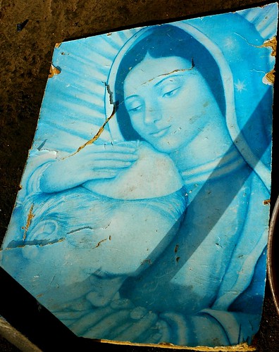 Our Lady of Guadalupe holding Pope John Paul, who prays, universal blue, poster in a folk shrine, northern Mexico by Wonderlane