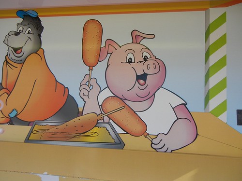 pig eating a corn dog