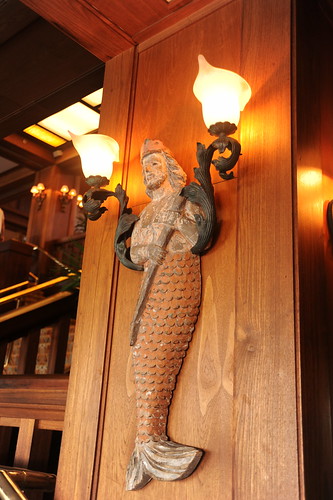 King Neptune, long hair, crown, fish tail lower body, upper torso of a man, sculpture, lamp, wood, brass, Monterey, California, USA by Wonderlane