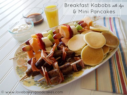 Breakfast Kabobs {with Dips} & Mini Pancakes on plate with a glass of orange juice. 