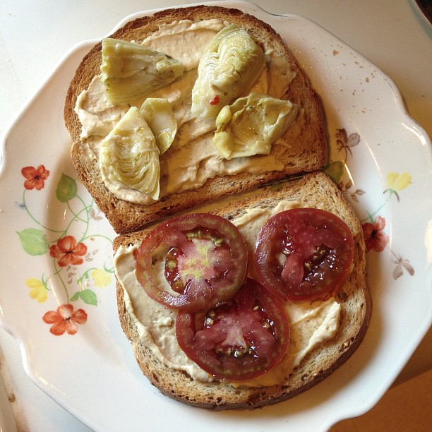 Lunch: toast, hummus, marinated artichoke hearts, homegrown black prince tomatoes, salt and pepper #vegan