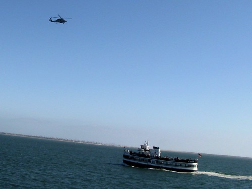 A United States Navy helicopter and a sightseeing cruise boat.  San Diego California.  June 2013. by Eddie from Chicago