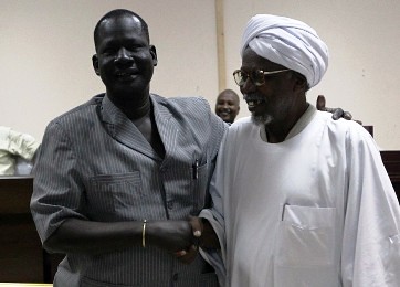 Sudanese Al-Amer Mokhtar Papo (R) a leader of the Misserya ethnic group and his counterpart from the Dinka Ngok group, Kual Deng Majok shake hands after signing a peace agreement in the town of Kadugli north of Abeyi on January 13, 2011. by Pan-African News Wire File Photos