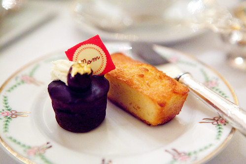 Gateau de Voyage cake topped with a chocolate "Mom" sign and financier