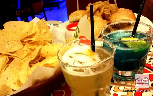 El Nino Margarita (left) & Blue Pacific Margarita (right); (Bottomless Tostada Chips with Skillet Queso and Big Mouth Burger Bites in the background)
