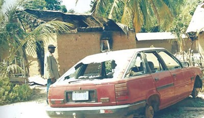 A destroyed vehicle in Nigeria where civil and communal unrest has spread throughout the West African state. President Jonathan has declared a state of emergency in three northeastern states. by Pan-African News Wire File Photos