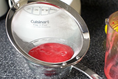 straining the raspberry puree 