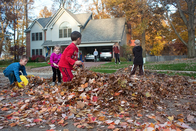 Kids playing in leaves via The Risky Kids