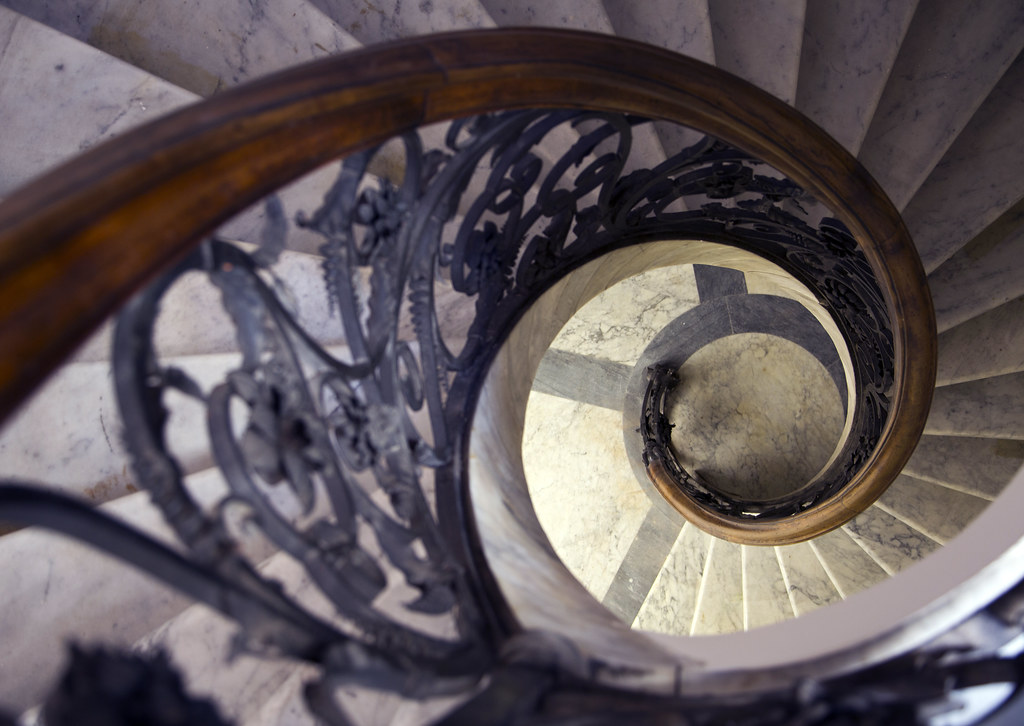Ornate spiral stairwell leading to the library.