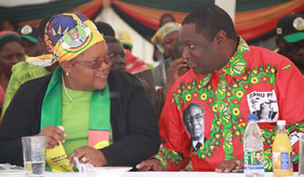 Republic of Zimbabwe Vice President Joice Mujuru chats with Mbare National Assembly candidate and Politburo member Cde Tendai Savanhu at a Zanu-PF campaign rally ib Number 5 grounds in Mbare on Saturday July 13, 2013. by Pan-African News Wire File Photos