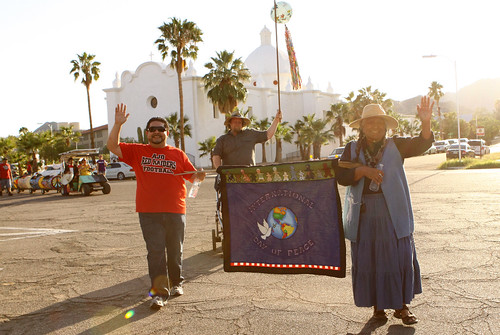 Ajo, Arizona’s Sonoran Desert Retreat Center recently received an ArtPlace grant to promote small town vitality. The town’s annual International Day of Peace parade brings together people from the Tohono O’odahm Nation and Sonoyta, Mexico.  Pictured here Eric Alegria (board chair of the Center), Lorraine Marquez Eiler of the Hla C-ed O’odham district on the Tohono O’odham Nation legislative Council, and (behind) Brian Mackenzie, the principal of the Ajo school. Photo courtesy of Tracy Taft.  