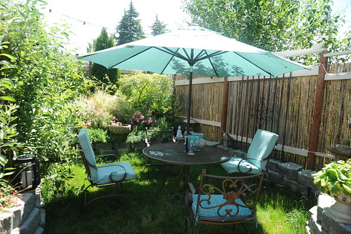 Hot summer day, patio table, umbrella and chairs, sea foam green, fencing from Pioneer's Square, bamboo fence, lotus fountain, carpet roses,A Garden for the Buddha, Seattle, Washington, USA by Wonderlane