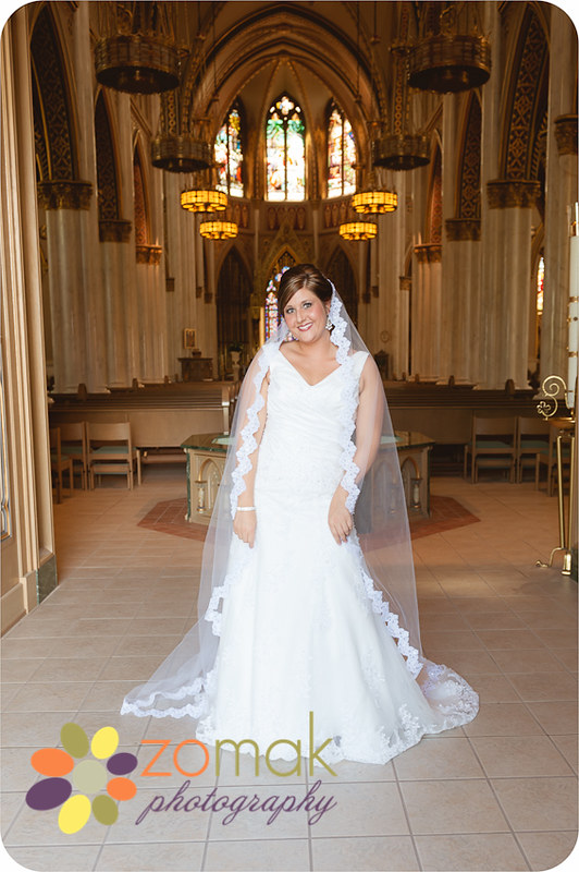 Beautiful bride stands in the doorway to the St helena Cathedral just before seeing her groom on their wedding day