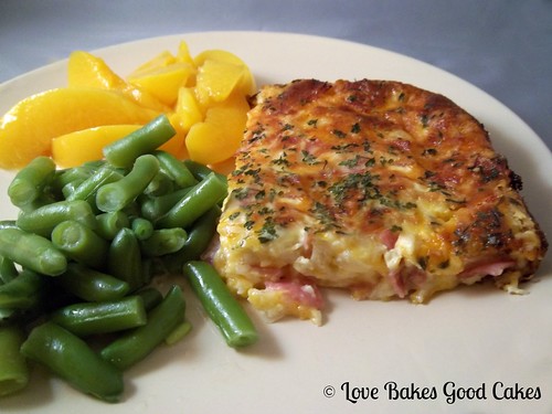 Crustless Ham Savory Bake with green beans and peach slices on plate.