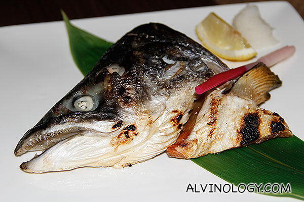 Separate order of grilled salmon fish head for sharing  