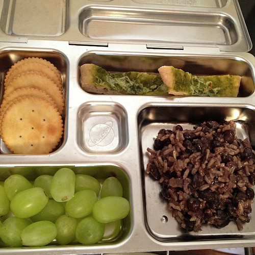 Reno's Lunch: Her Nonna's Rice and Beans, leftover mini pesto and #vegan cheese pizza, grapes, crackers. #planetbox