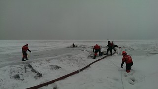 Coast Guard crew members from Station Calumet Harbor and first responders from the Chicago Fire Department rescue a man from Lake Michigan, Jan. 2, 2014. Both agencies worked together to safely remove the man from the ice who was then transferred to a local hospital. (Coast Guard photo by Petty Officer 2nd Class John Palmer)