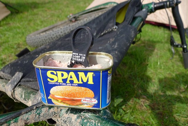 Front, close up view of a can of SPAM, sitting on top of a Surly bike shown from the rear, laying on it's right side