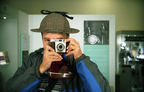reflected self-portrait with Kodak ColorSnap 35 camera and deer-stalker by pho-Tony