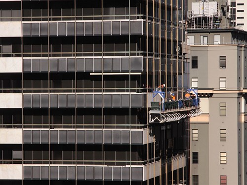 Installing steel mesh panels on the facade of 447 Collins Street