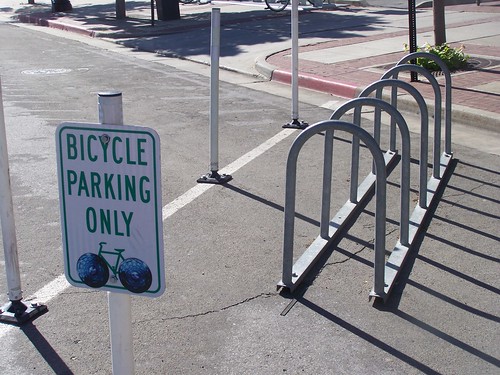 Street bicycle corral, 300 West next to Squatters, with a bicycle parking sign