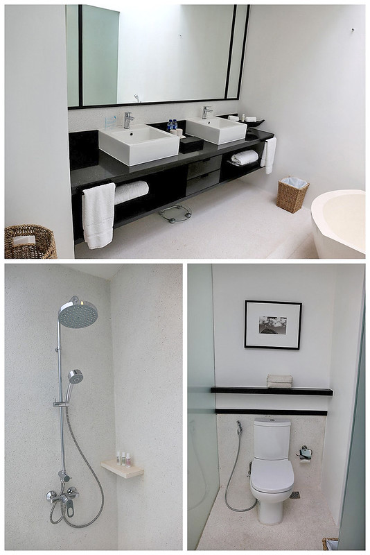 The bathroom has separate shower and toilet facilities, as well as double washbasins