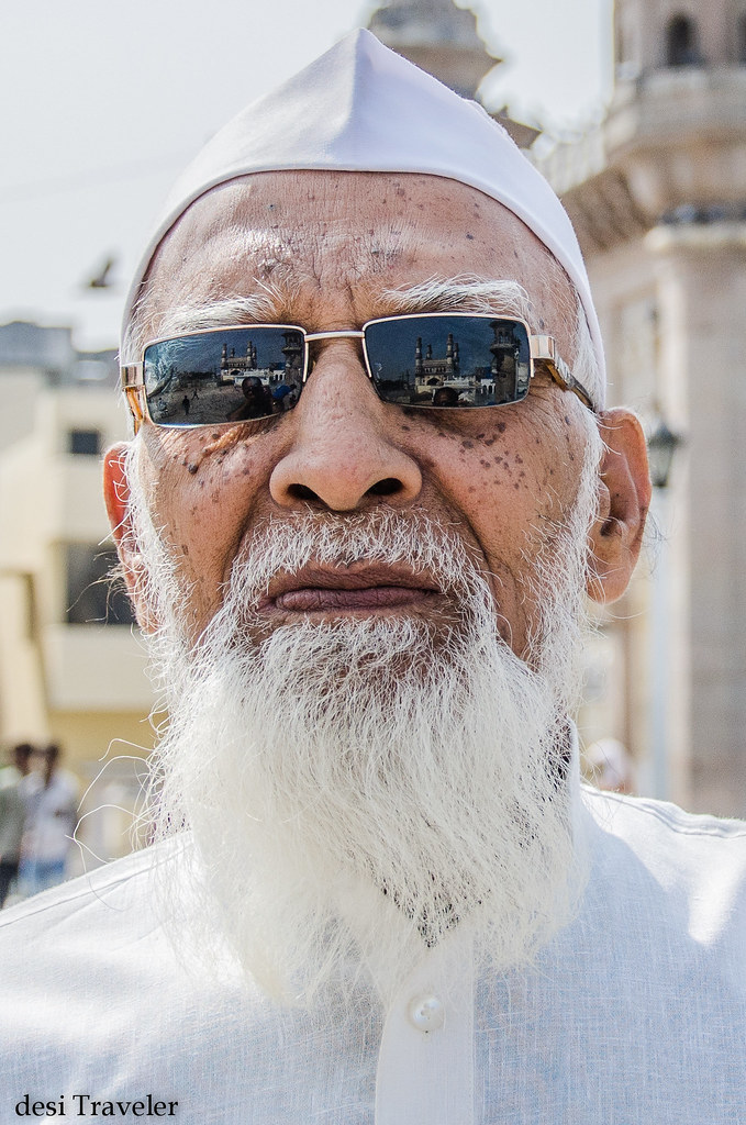 charminar in reflections of sunglasses of an old man