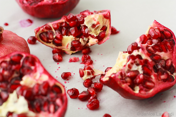 Removing the seeds from a pomegranate.