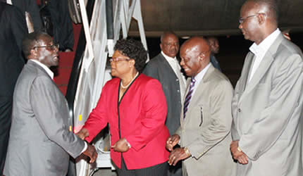 President Mugabe is welcomed at the Harare International Airport by Vice-President Mujuru soon after returning from the African Union Summit in Addis Ababa last night. Looking on is Minister of State for Presidential Affairs Didymus Mutasa, Information, M by Pan-African News Wire File Photos