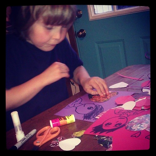 Expert valentine maker says, "Don't take my picture. It's in PROGRESS!" #valentine #son #papercrafts #holiday #homemade #love. #loveinthesuburbs
