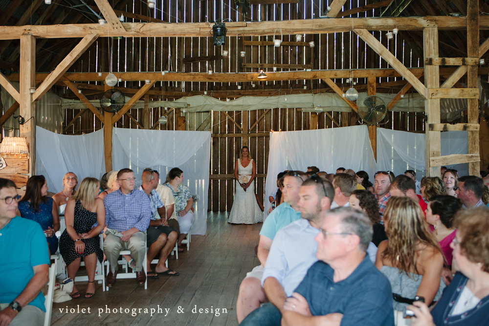 Bride walking down the barn aisle
