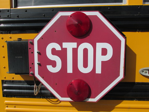 The electric flashing safety stop sign flag on an AGF Transportation Company school bus.  Summit Illinois.  March 2014. by Eddie from Chicago