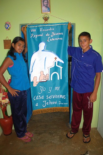 Karelis and Pedro Santana with the banner they took to the youth encounter.