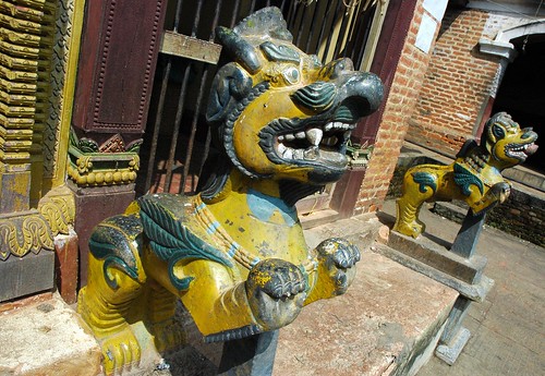 Symbols of protection, yellow and green lions protecting the Pamting Brothers Tibetan Buddhist and Nepalese shrine to Vajrayogini, Pharping, Nepal by Wonderlane