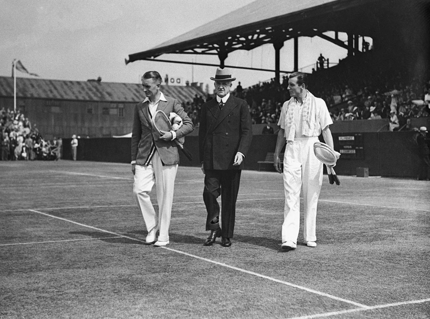 Australian tennis player Jack Crawford (left) and British tennis player Fred Perry (right) at the White City Stadium in Sydney, Australia with a senior tennis offical (center) 1930s
