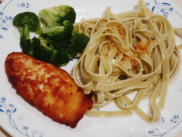 Top Torikatsu breaded chicken fillet with spinach pasta with garlic olive oil and broccoli