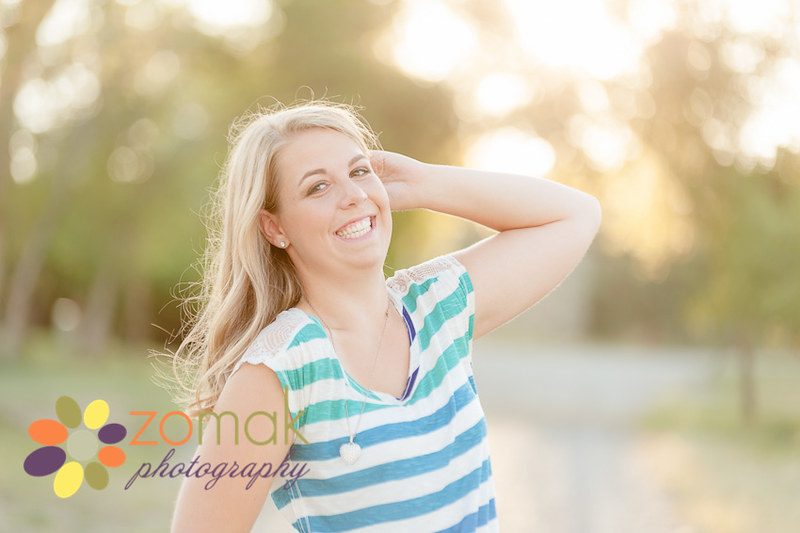 Helena High Class of 2014 senior smiling at sunset in a backlit location 