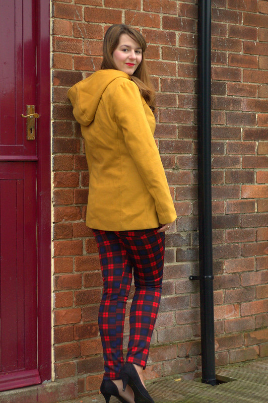 Mustard coat, mustard jumper, tartan trousers, heels