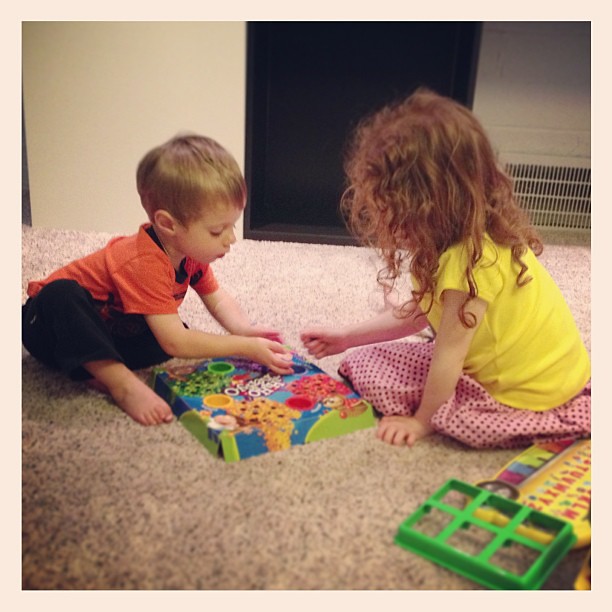 Happily playing a game together in their new playroom.  #renovation