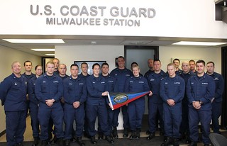 Capt. Matthew Sibley (left), commander of Coast Guard Sector Lake Michigan, poses with crew members from Coast Guard Station Milwaukee after presenting the unit with the Sumner I. Kimball Award for Excellence, Jan. 31, 2014. The Kimball Award recognizes Coast Guard small boat stations that demonstrate excellence in operational readiness and vessel condition. U.S. Coast Guard photo by Lt. Brian Dykens