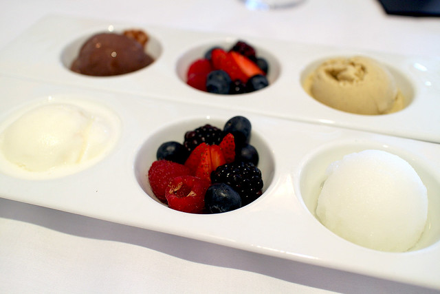 Scoops of gelato with fresh fruit - chocolate, pistachio, vanilla and lemon